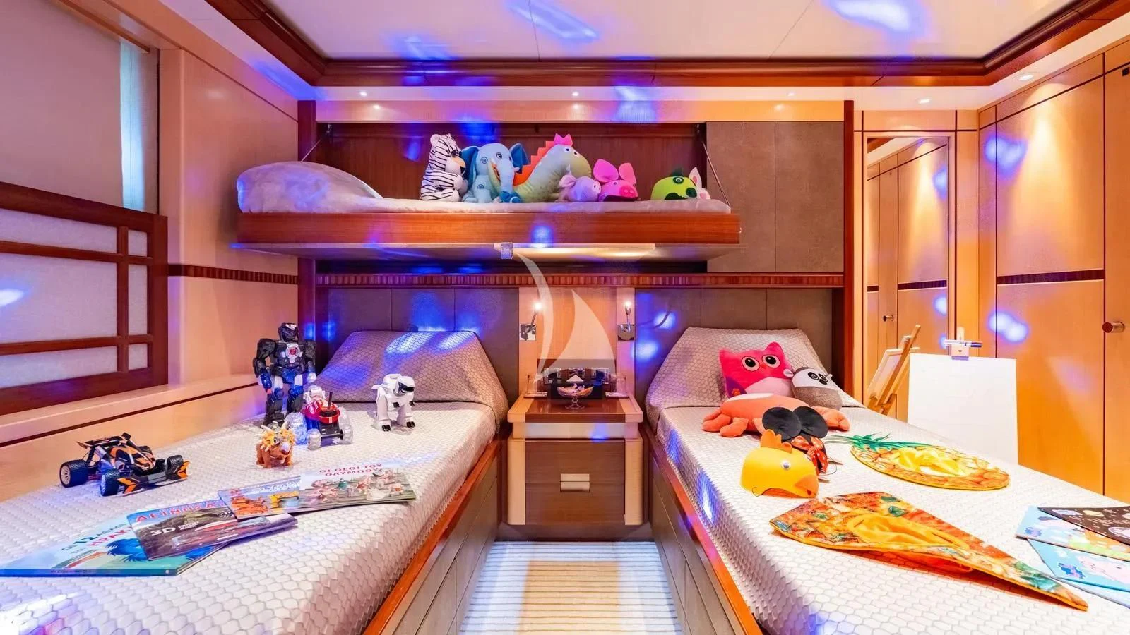 a room with a bed and stuffed animals aboard RARE FIND Yacht for Charter