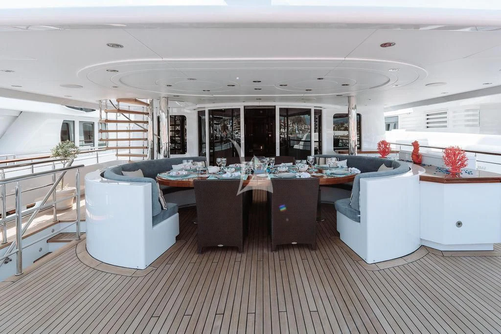 a large room with a large table and chairs aboard RARE FIND Yacht for Charter