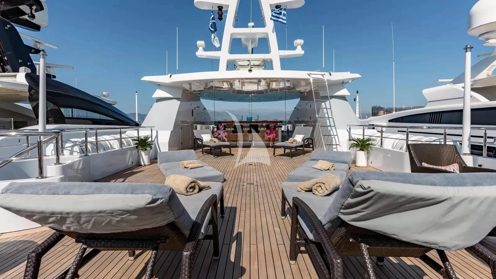 a deck with a large cruise ship in the background aboard RARE FIND Yacht for Charter