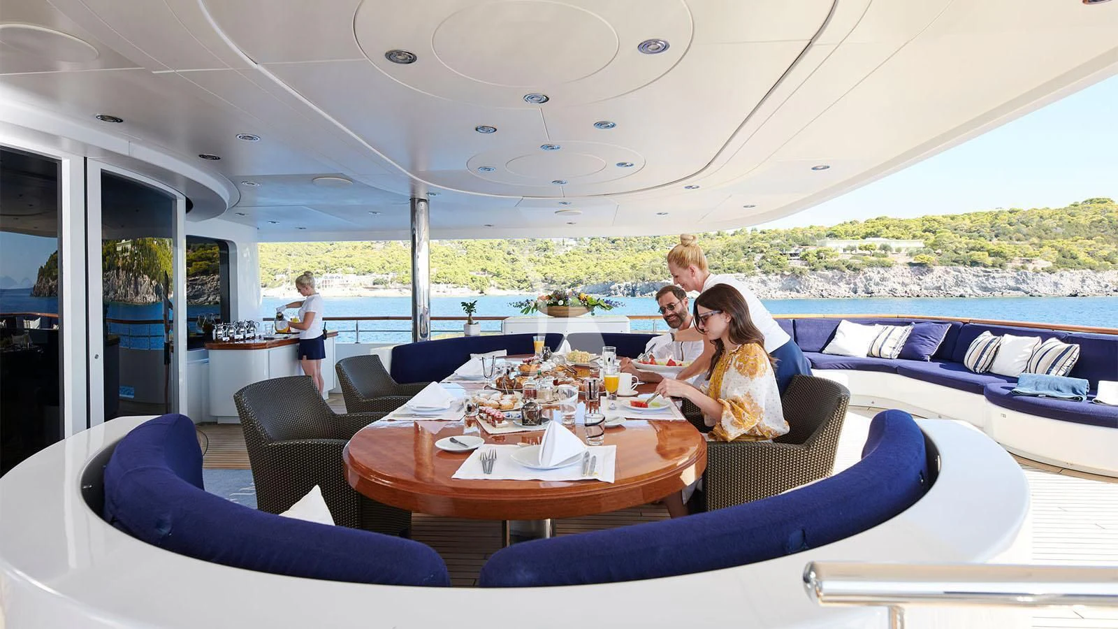 a group of people sitting around a table aboard RARE FIND Yacht for Charter