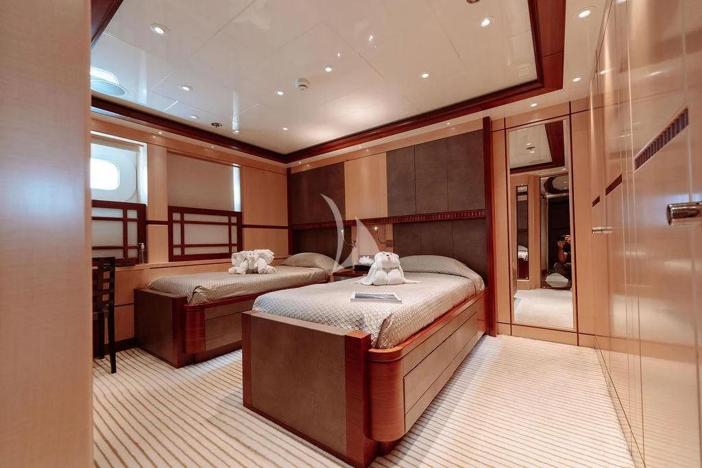 a room with a bed and a mirror aboard RARE FIND Yacht for Charter