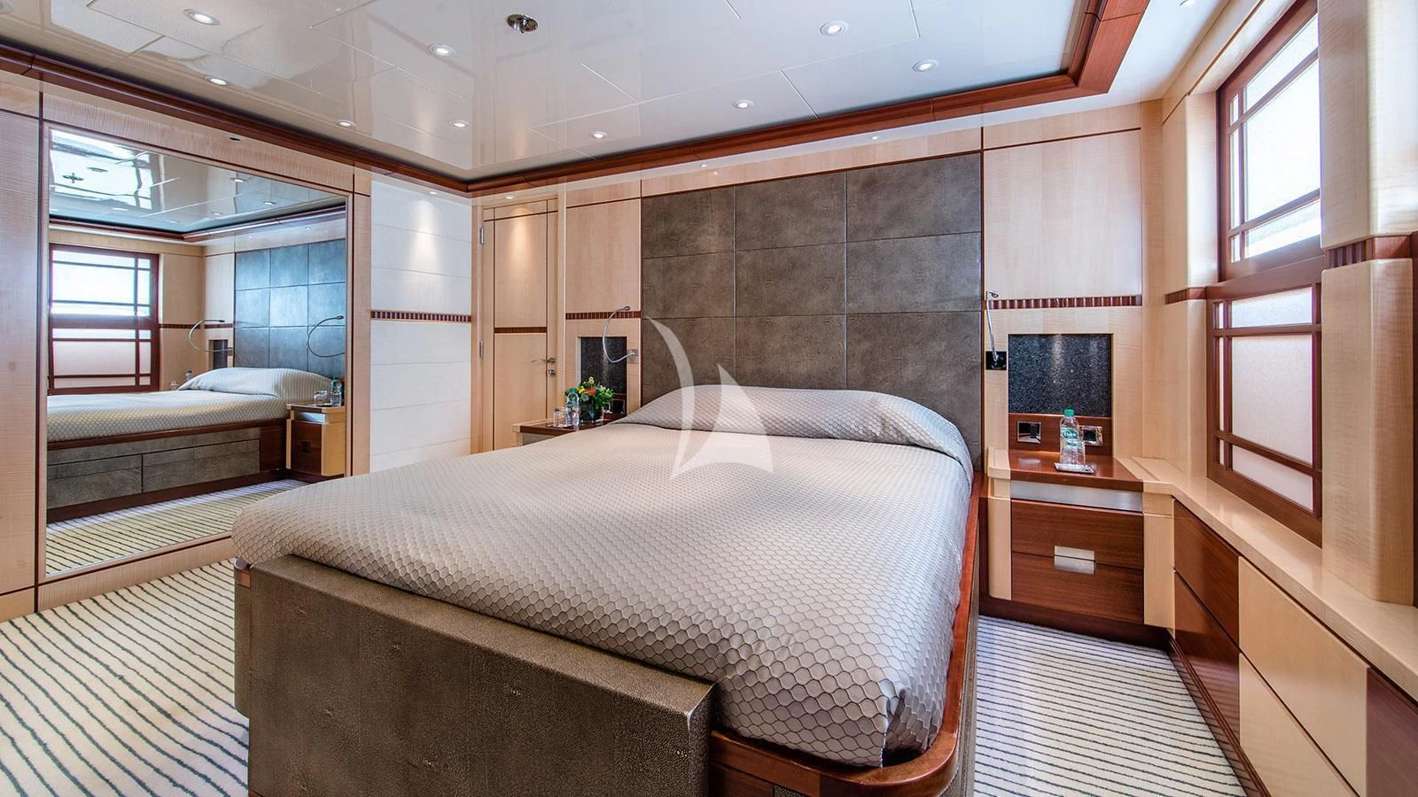 a bedroom with a bed and a window aboard RARE FIND Yacht for Charter