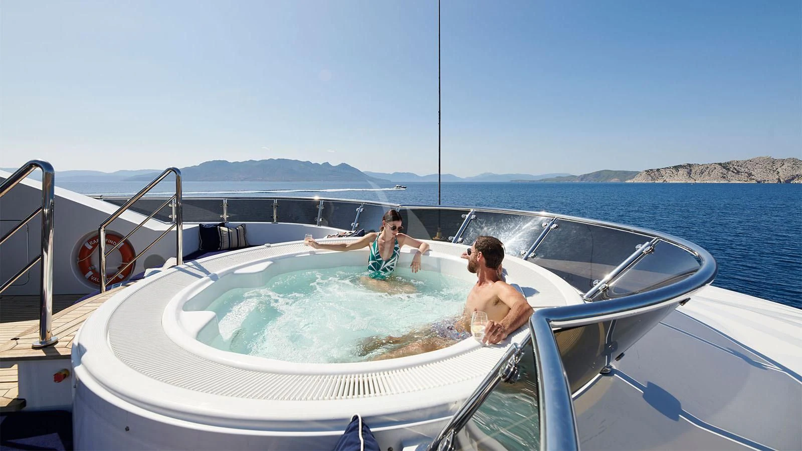 a couple of people sitting in a boat aboard RARE FIND Yacht for Charter