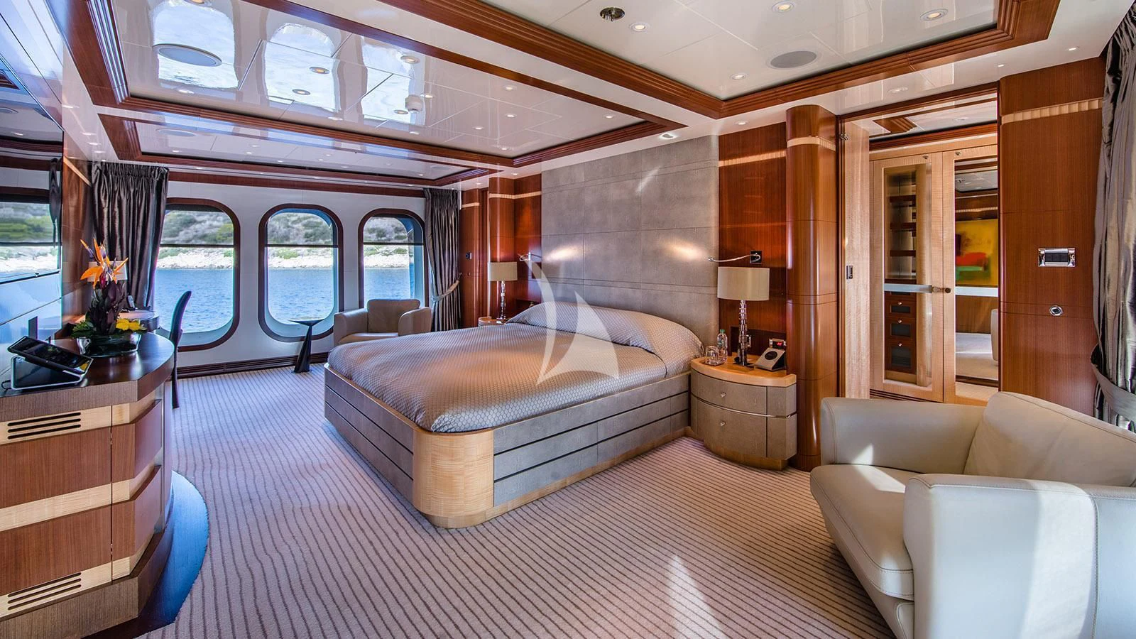 a large bedroom with a bed and a couch aboard RARE FIND Yacht for Charter