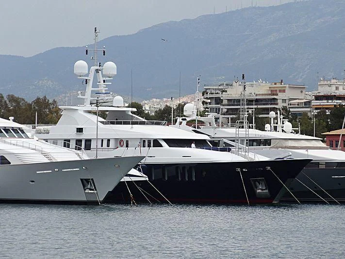 a few large boats are parked in the water aboard RARE FIND Yacht for Charter