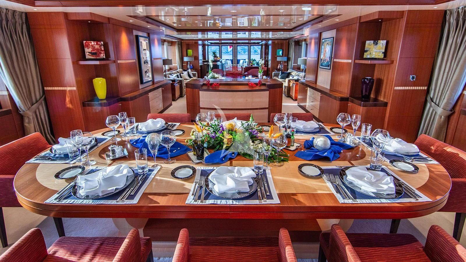 a large dining table with plates and glasses on it aboard RARE FIND Yacht for Charter