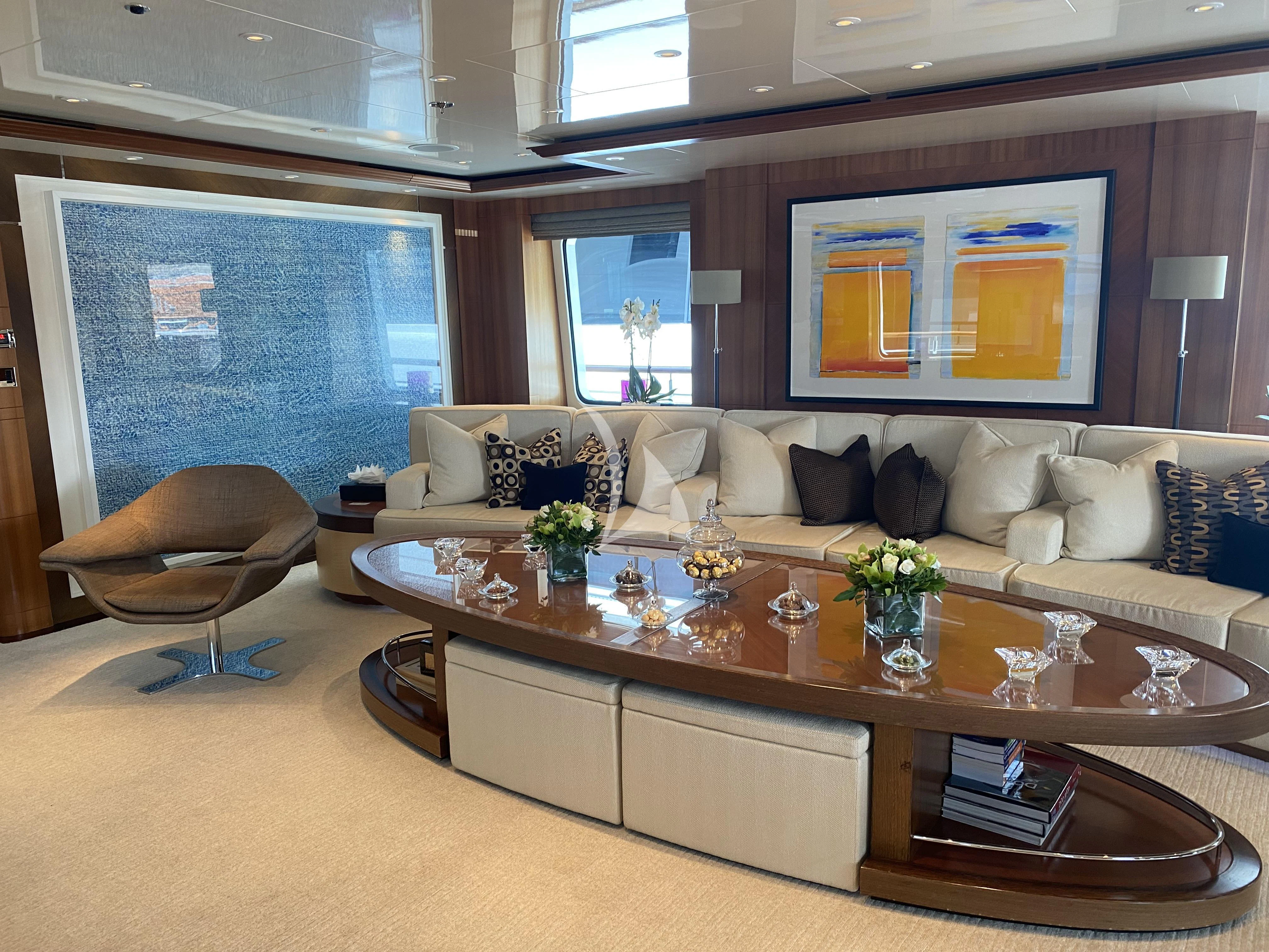 a living room with a large table and couches aboard RARE FIND Yacht for Charter