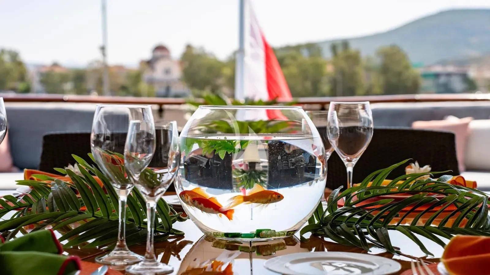 a table with wine glasses and plants aboard RARE FIND Yacht for Charter