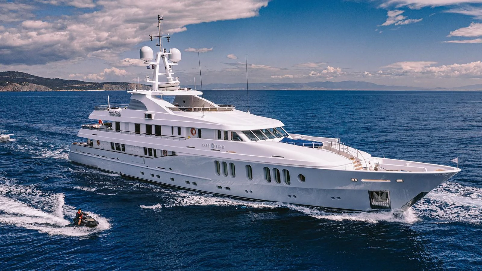 a large white boat in the water aboard RARE FIND Yacht for Charter