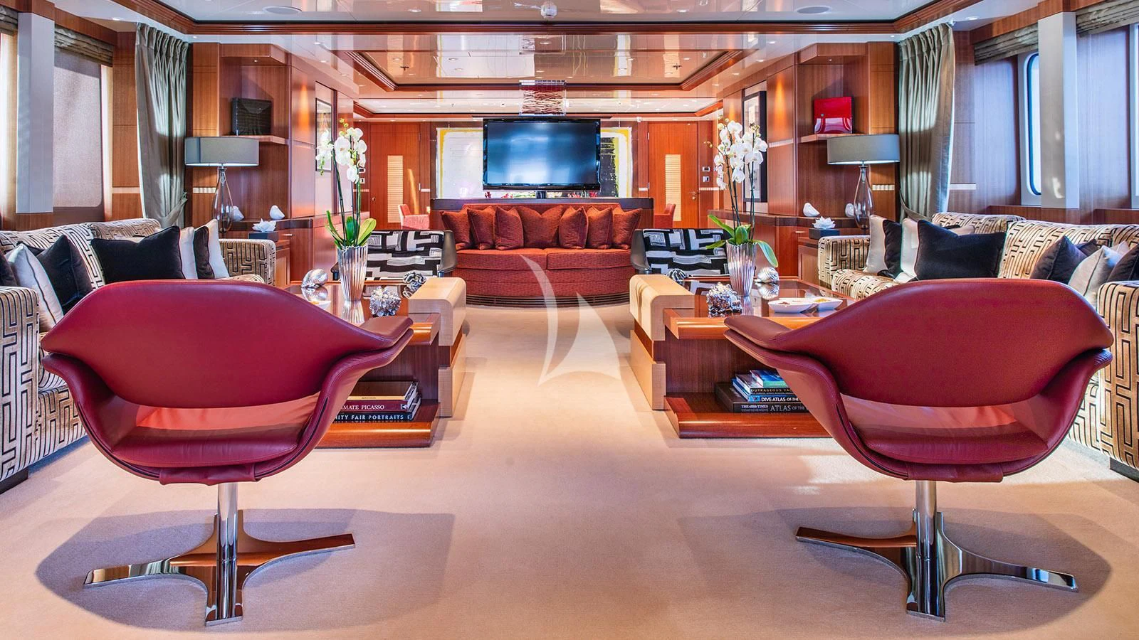 a living room with red chairs aboard RARE FIND Yacht for Charter
