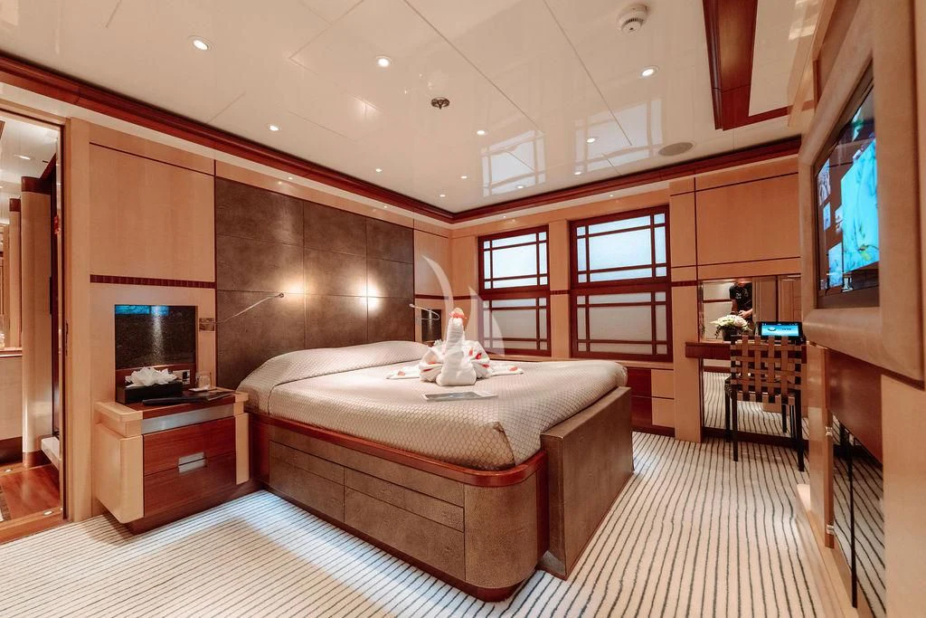 a bedroom with a bed and a window aboard RARE FIND Yacht for Charter