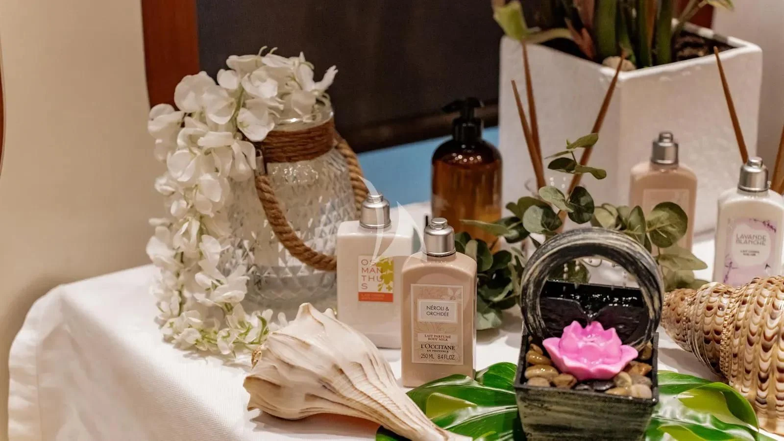 a table with flowers and bottles aboard RARE FIND Yacht for Charter