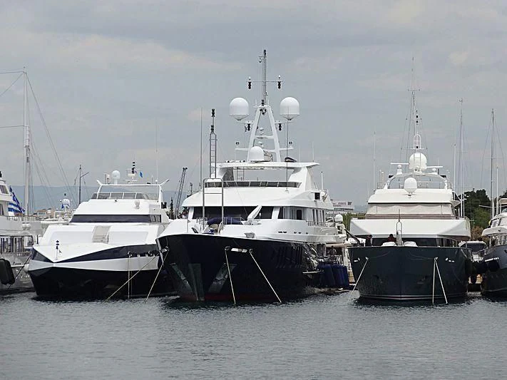 several boats are parked in a harbor aboard RARE FIND Yacht for Charter