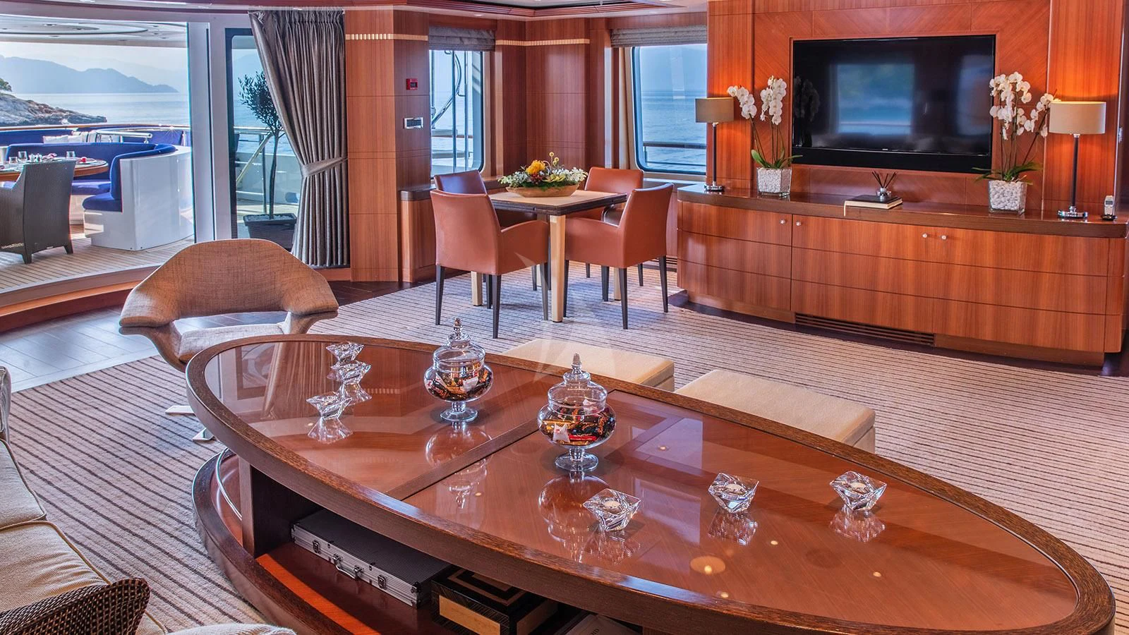 a large living room with a large table and chairs aboard RARE FIND Yacht for Charter