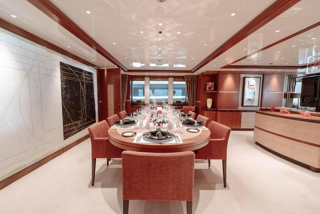 a room with a table chairs and a couch aboard RARE FIND Yacht for Charter