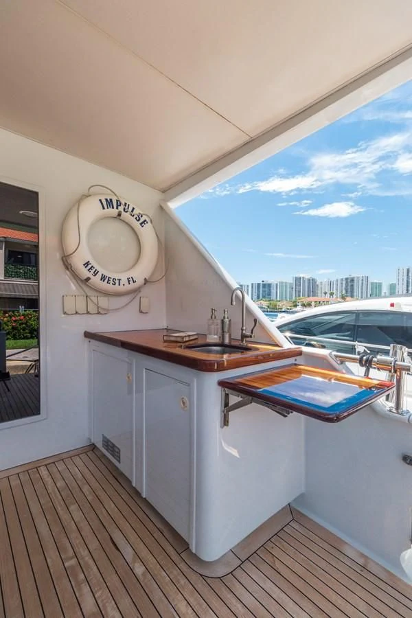 a kitchen with a sink and a window aboard IMPULSE Yacht for Sale