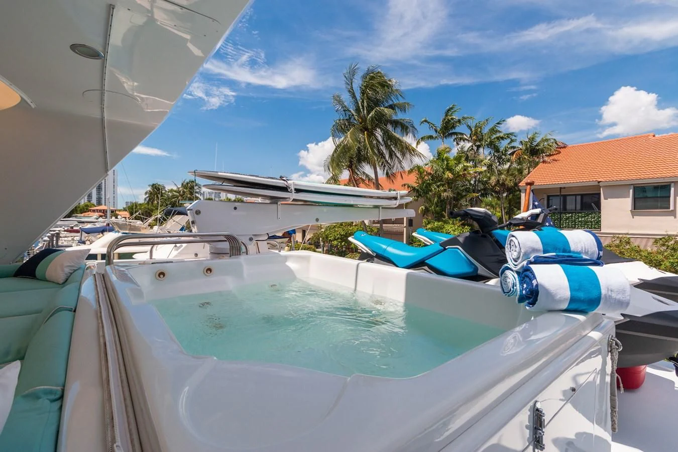 a pool with boats and palm trees aboard IMPULSE Yacht for Sale