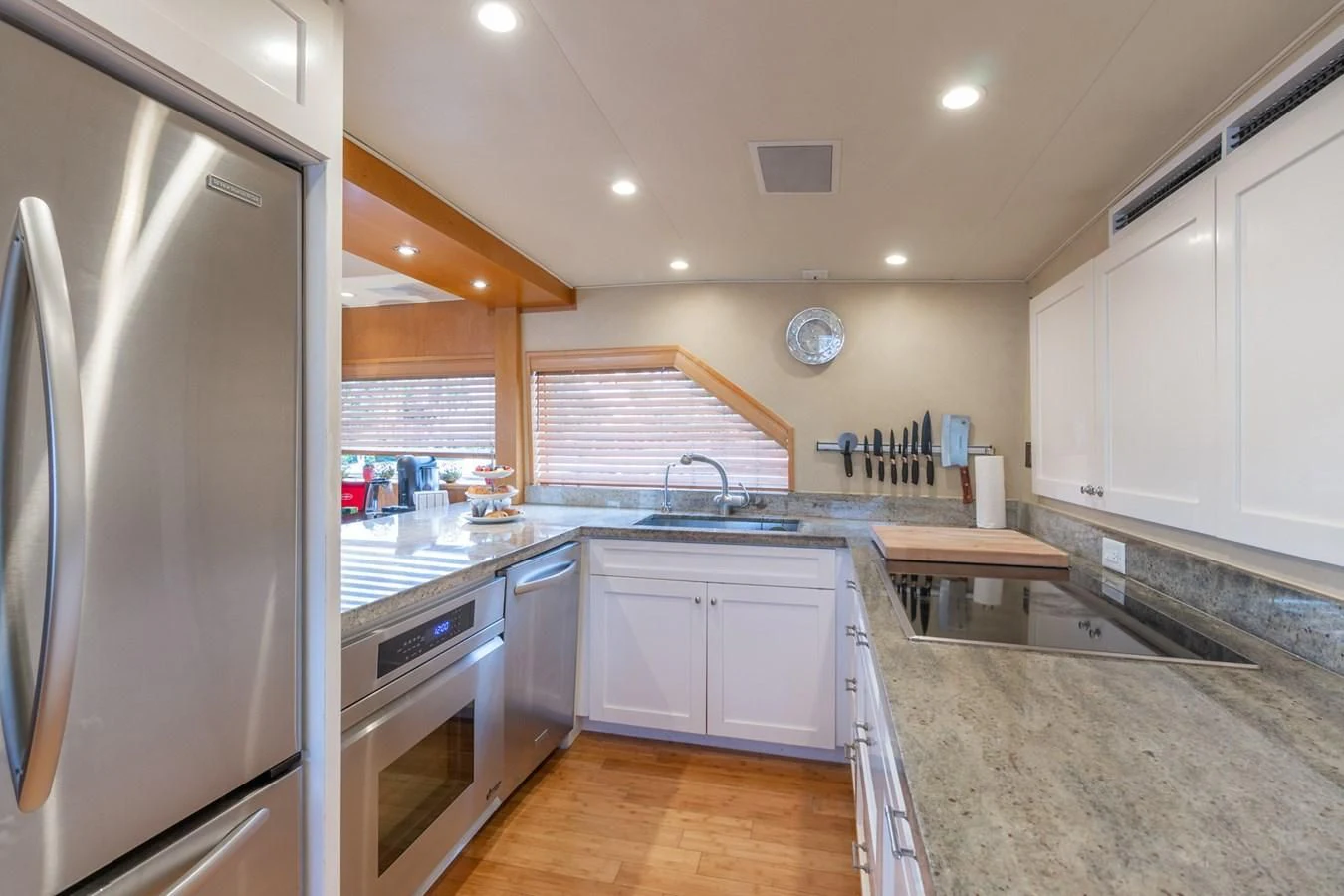 a kitchen with white cabinets aboard IMPULSE Yacht for Sale