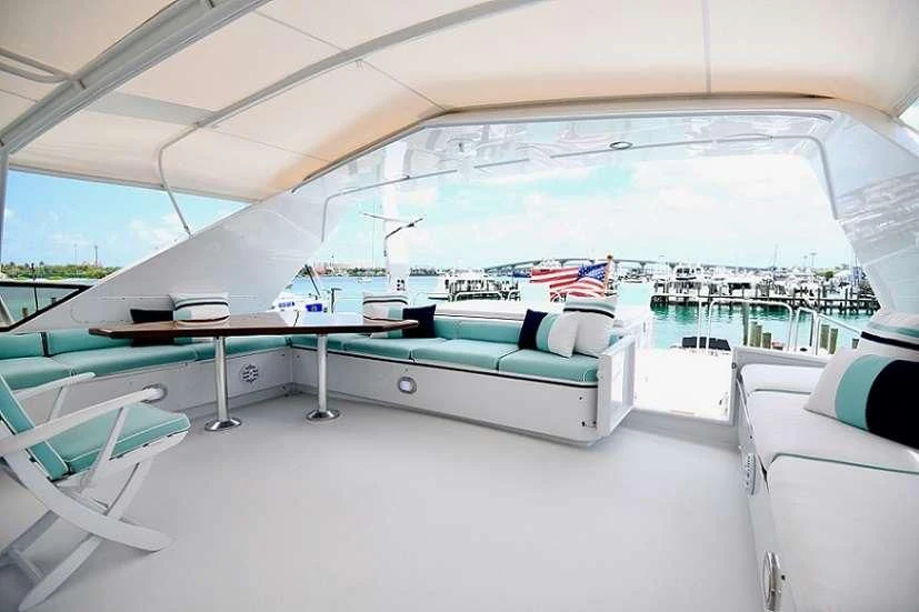 a large white lounge area with a pool and a deck with chairs aboard IMPULSE Yacht for Sale