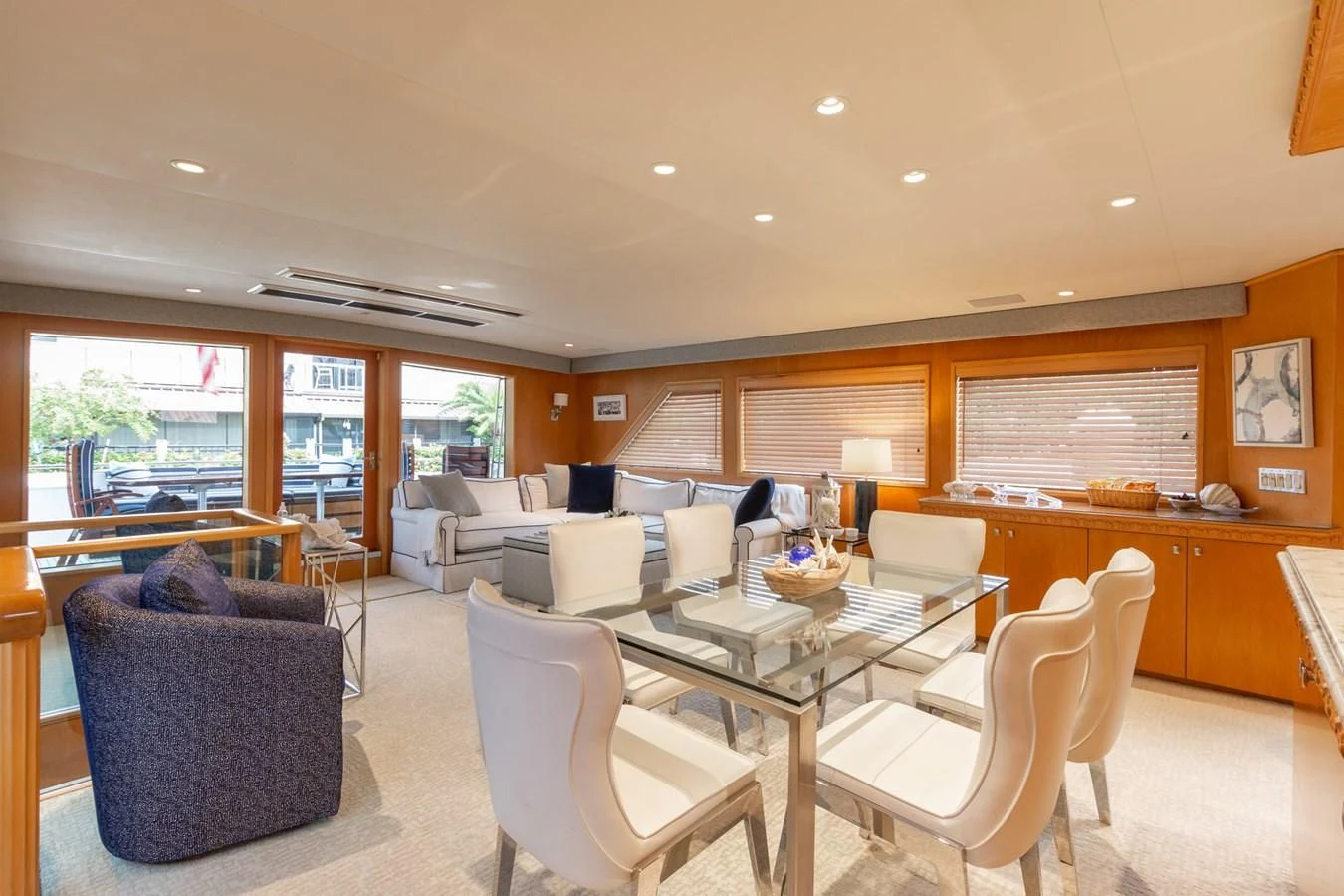 a large room with a table and chairs aboard IMPULSE Yacht for Sale