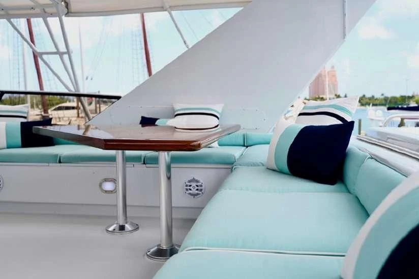 a white tent with a table and a book on it aboard IMPULSE Yacht for Sale