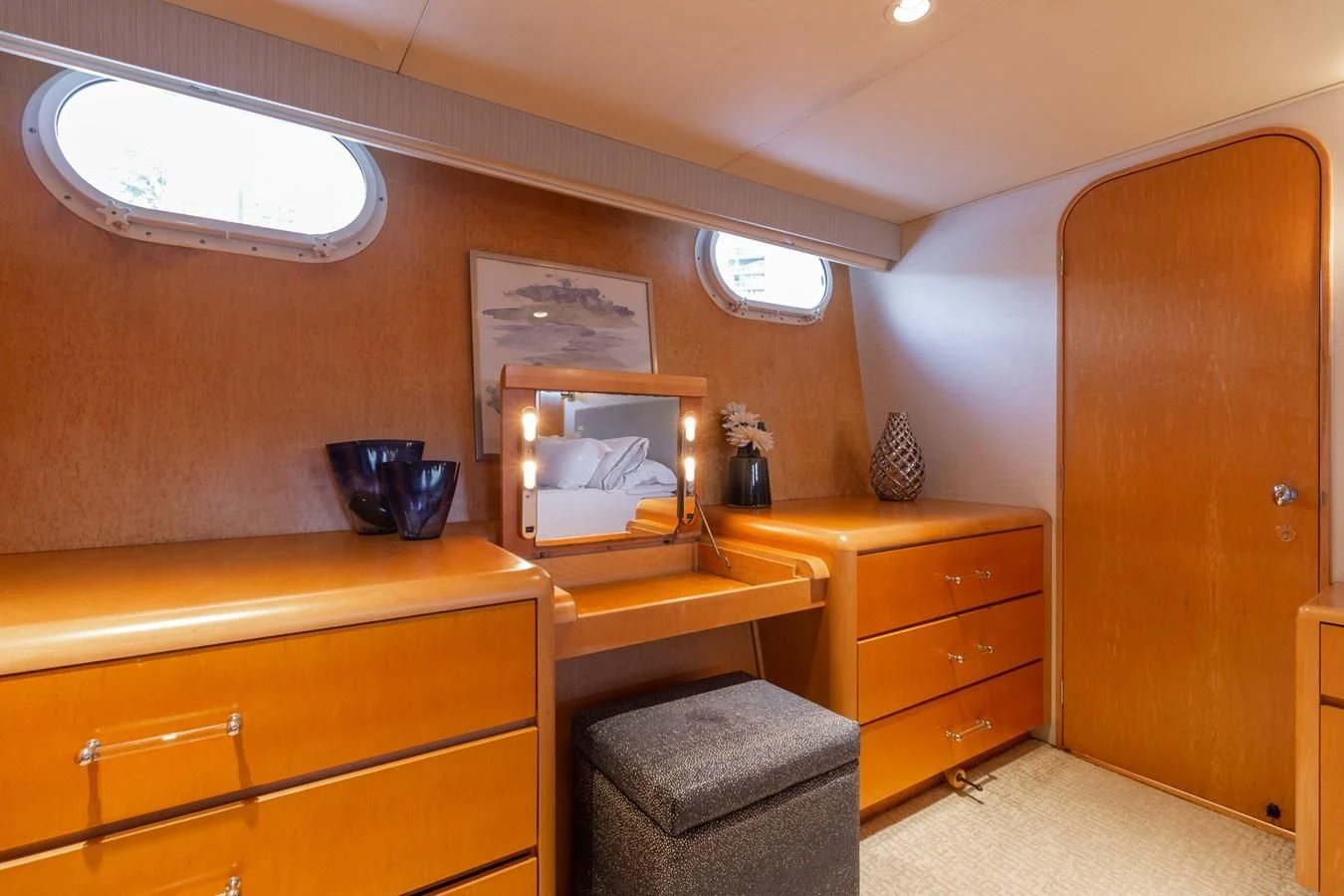 a bedroom with a desk and a bed aboard IMPULSE Yacht for Sale