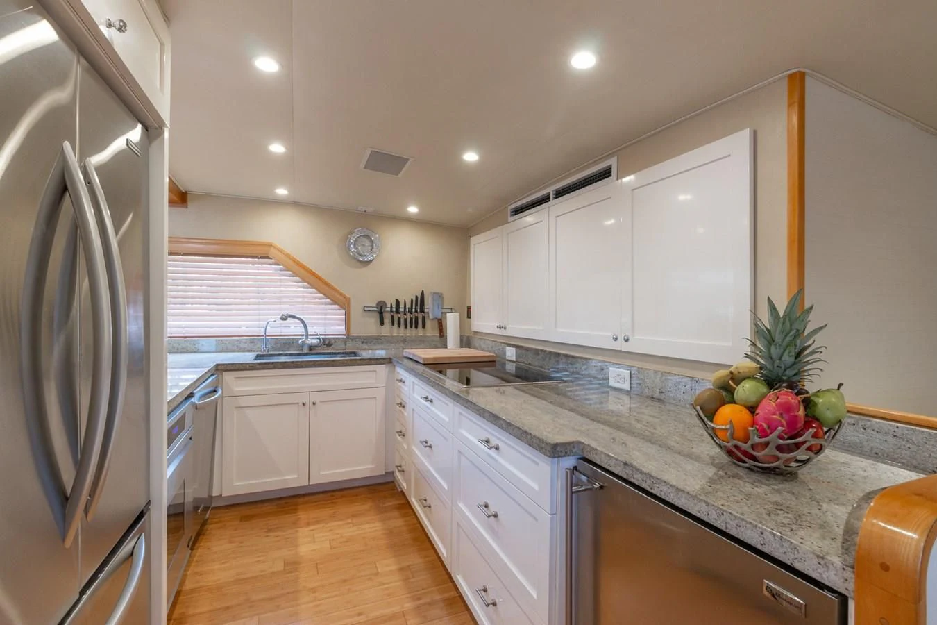 a kitchen with a stainless steel refrigerator aboard IMPULSE Yacht for Sale