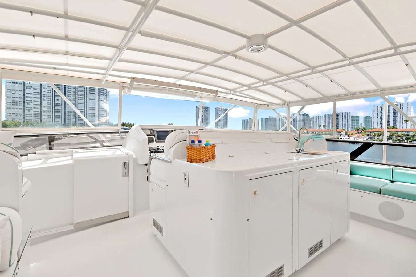 a large white kitchen with white cabinets aboard IMPULSE Yacht for Sale