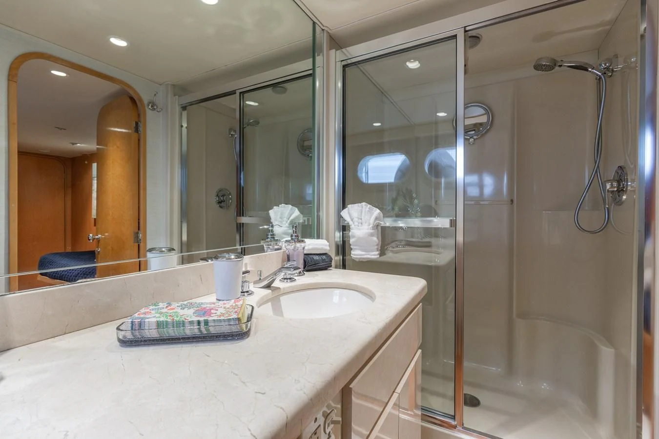 a bathroom with a shower and sink aboard IMPULSE Yacht for Sale