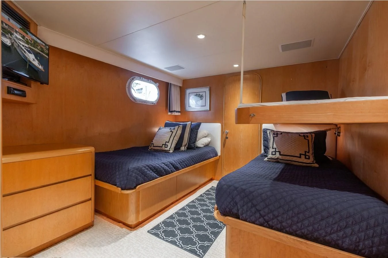 a room with a bed and a tv aboard IMPULSE Yacht for Sale