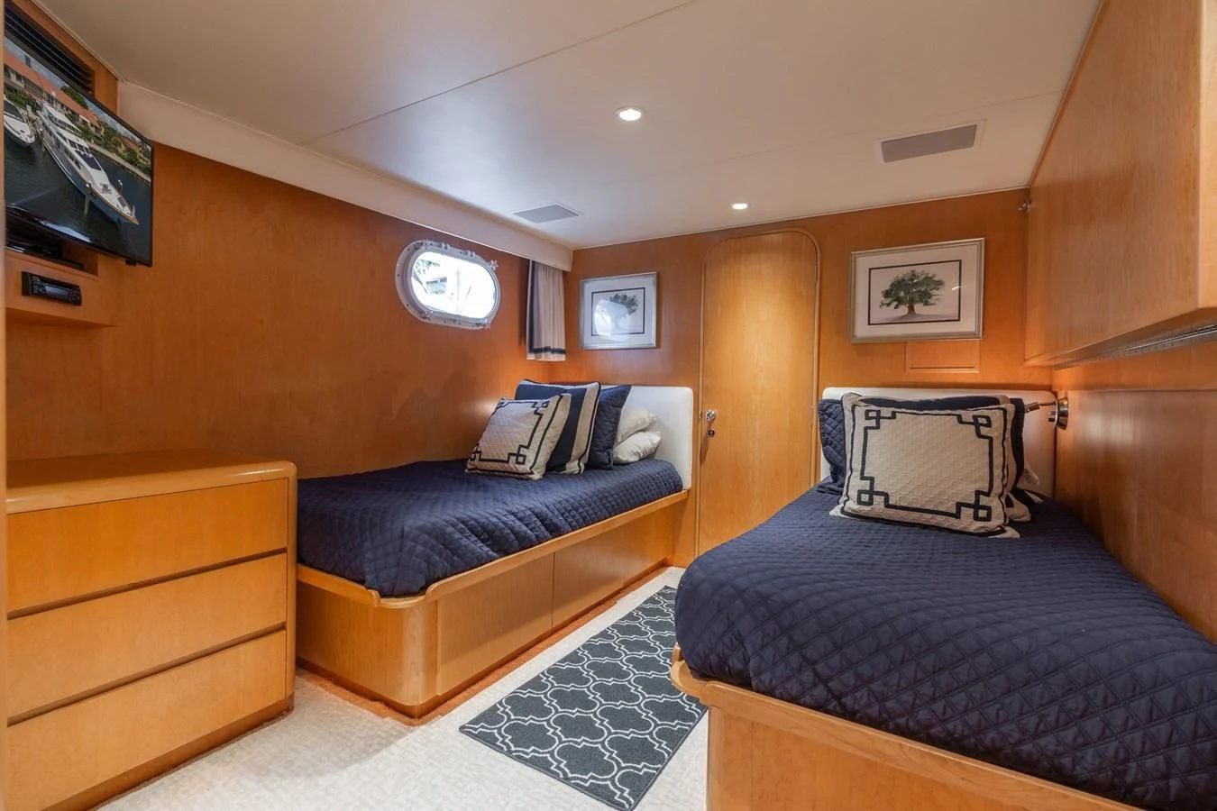 a room with a bed and a tv aboard IMPULSE Yacht for Sale
