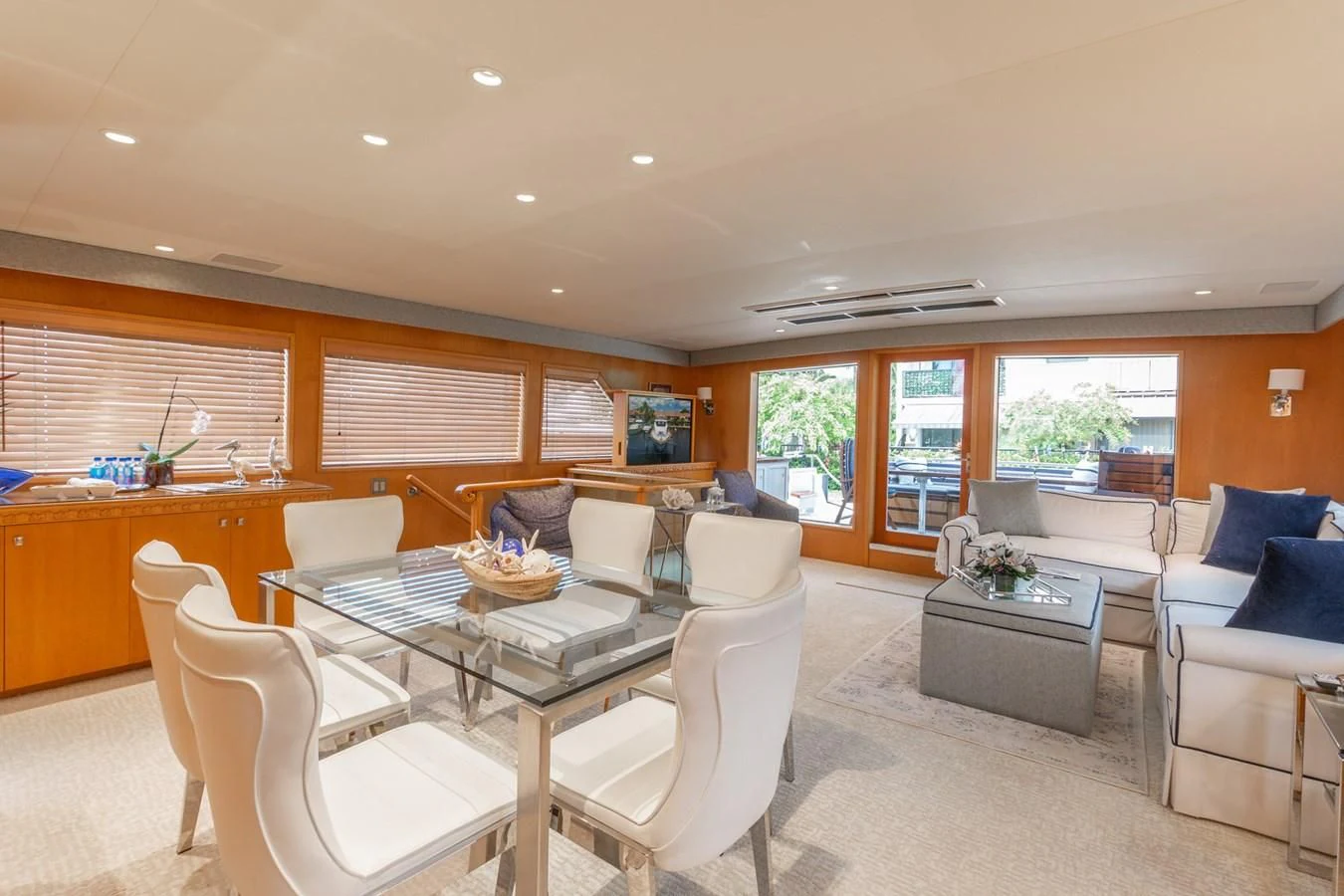 a large living room with a large table and chairs aboard IMPULSE Yacht for Sale