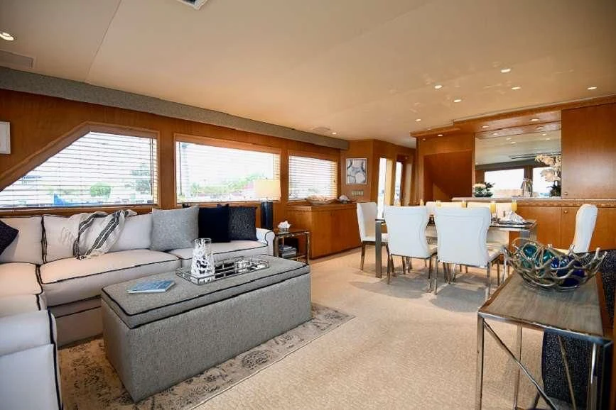 a living room with a couch and a table aboard IMPULSE Yacht for Sale
