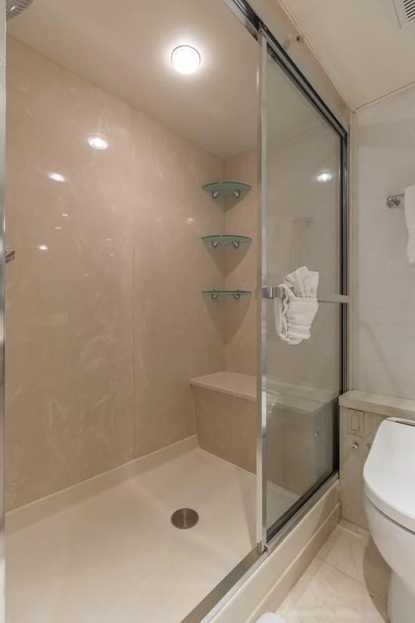 a bathroom with a glass shower aboard IMPULSE Yacht for Sale