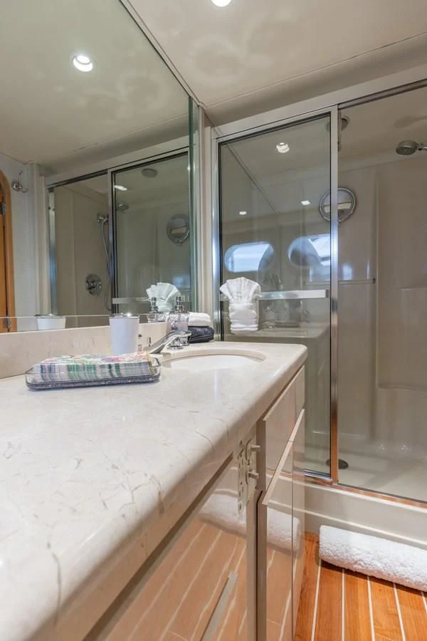 a bathroom with a large glass shower aboard IMPULSE Yacht for Sale