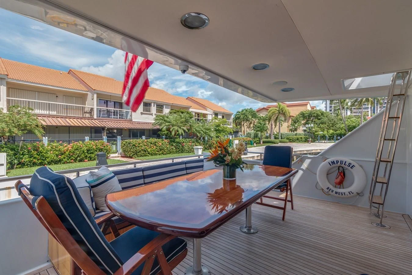 a patio with a table and chairs aboard IMPULSE Yacht for Sale