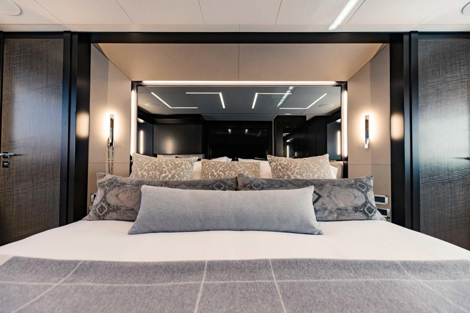 a bed with a white bed spread aboard STALLION Yacht for Sale