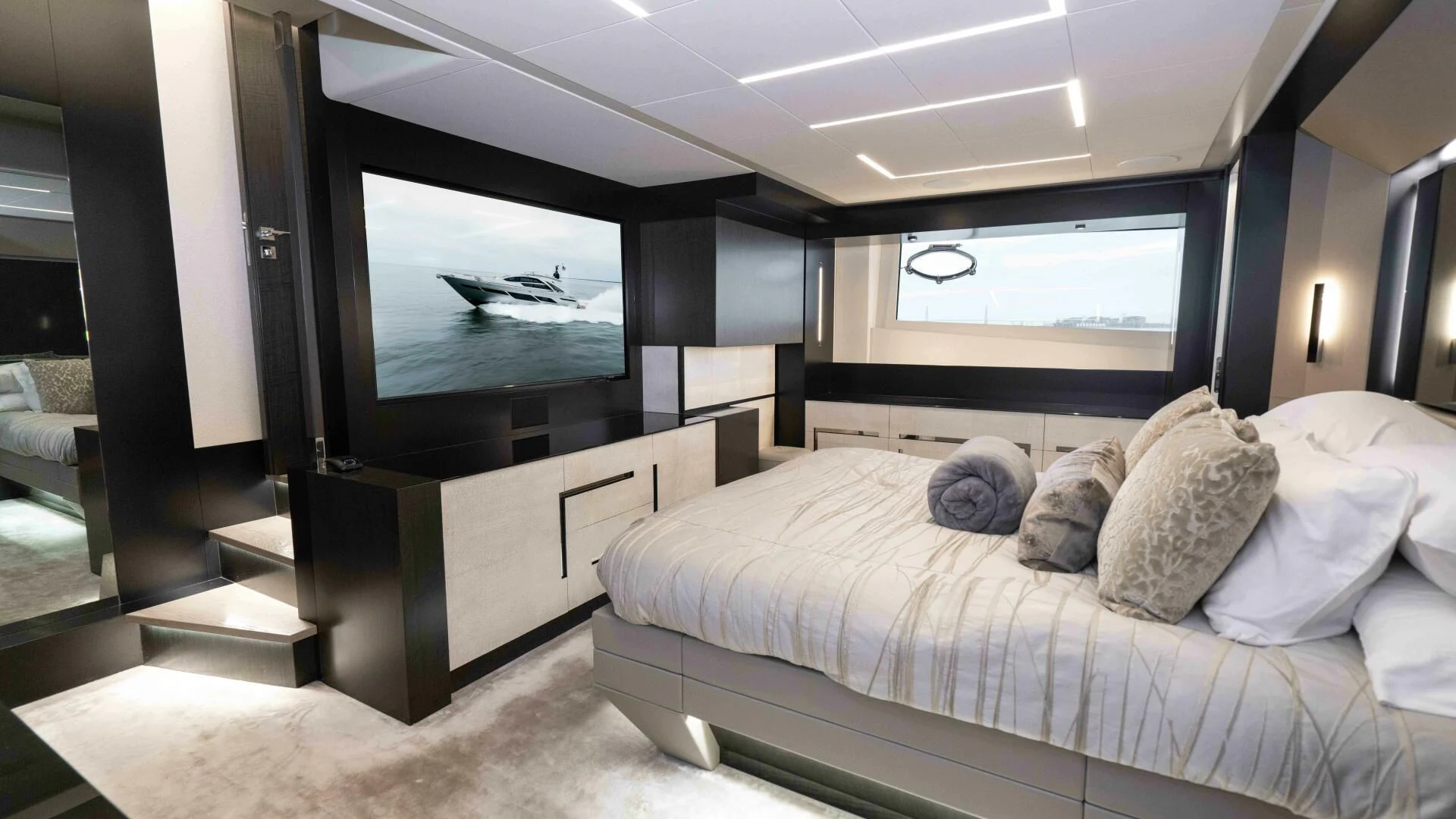 a bed with pillows and a television aboard STALLION Yacht for Sale