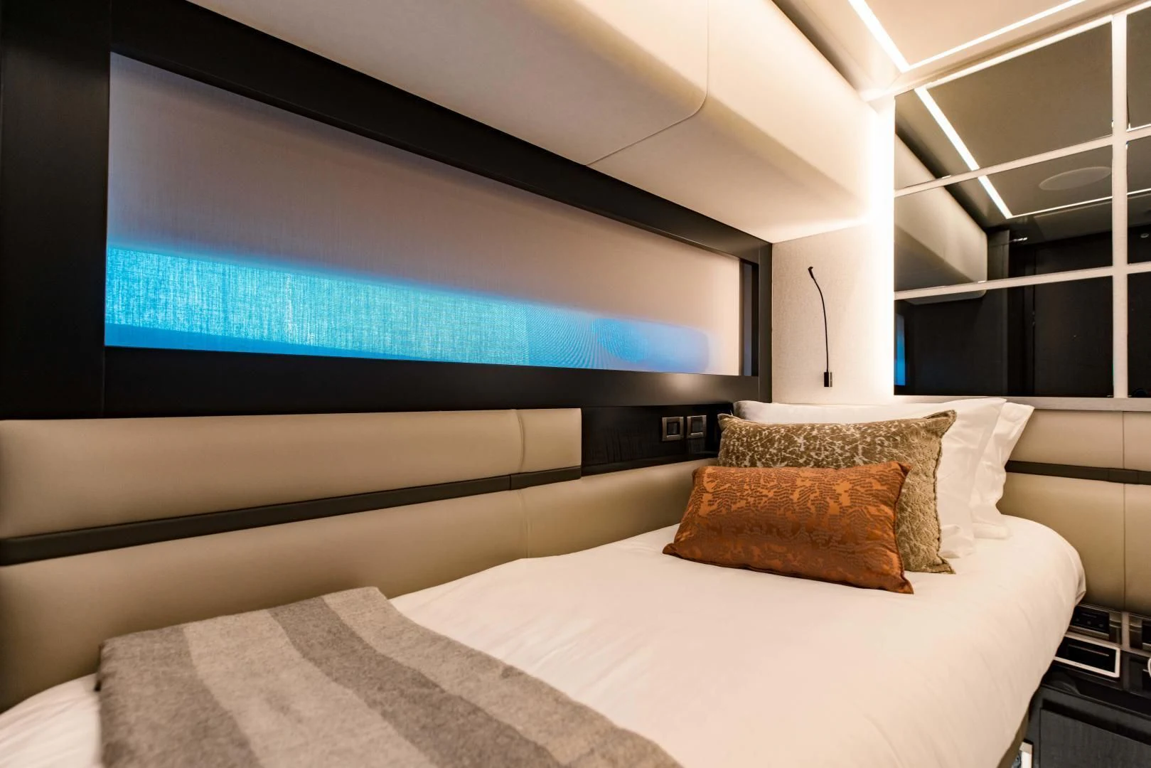 a bed with a television on the wall aboard STALLION Yacht for Sale