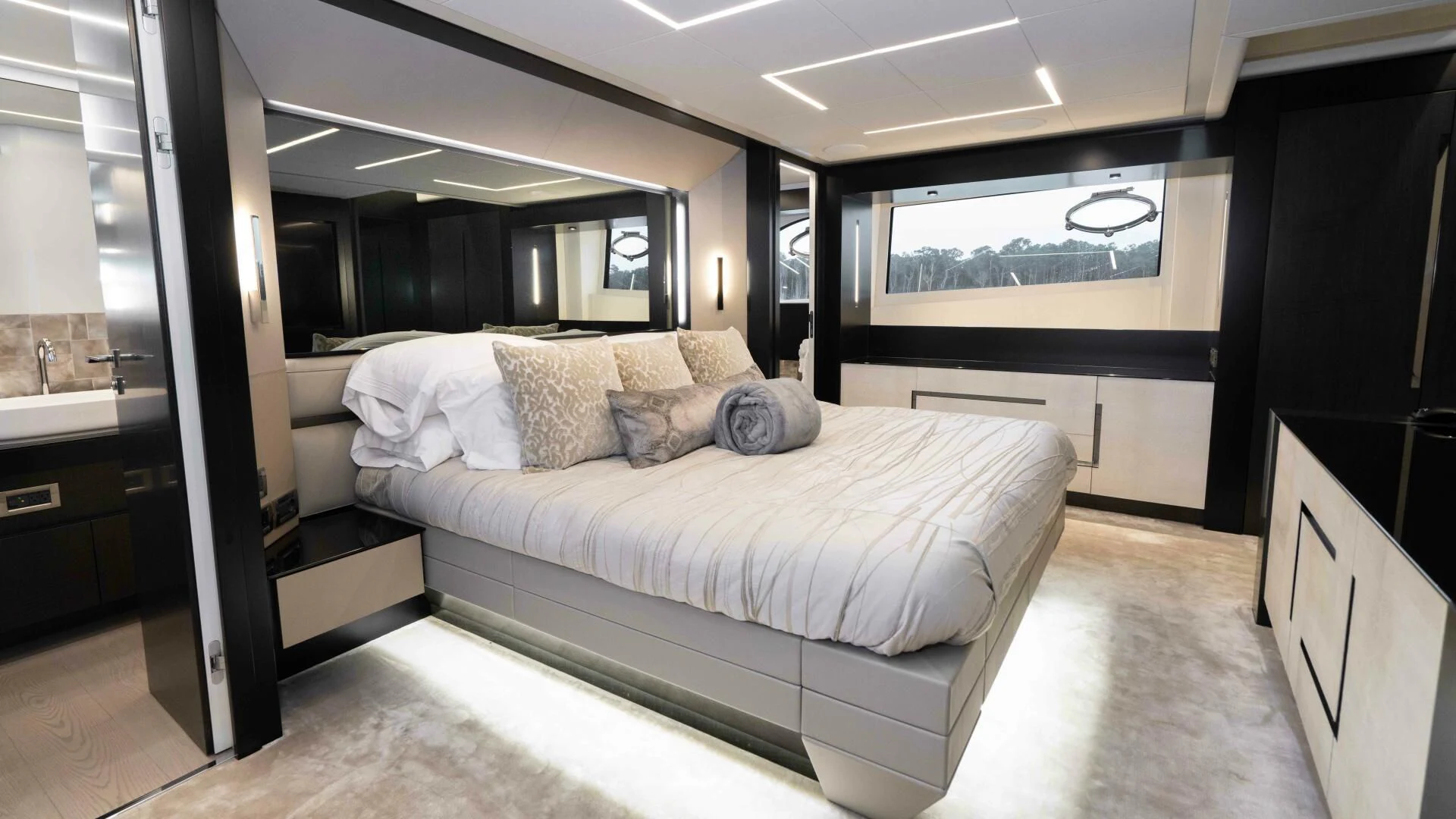 a bedroom with a bed and a mirror aboard STALLION Yacht for Sale