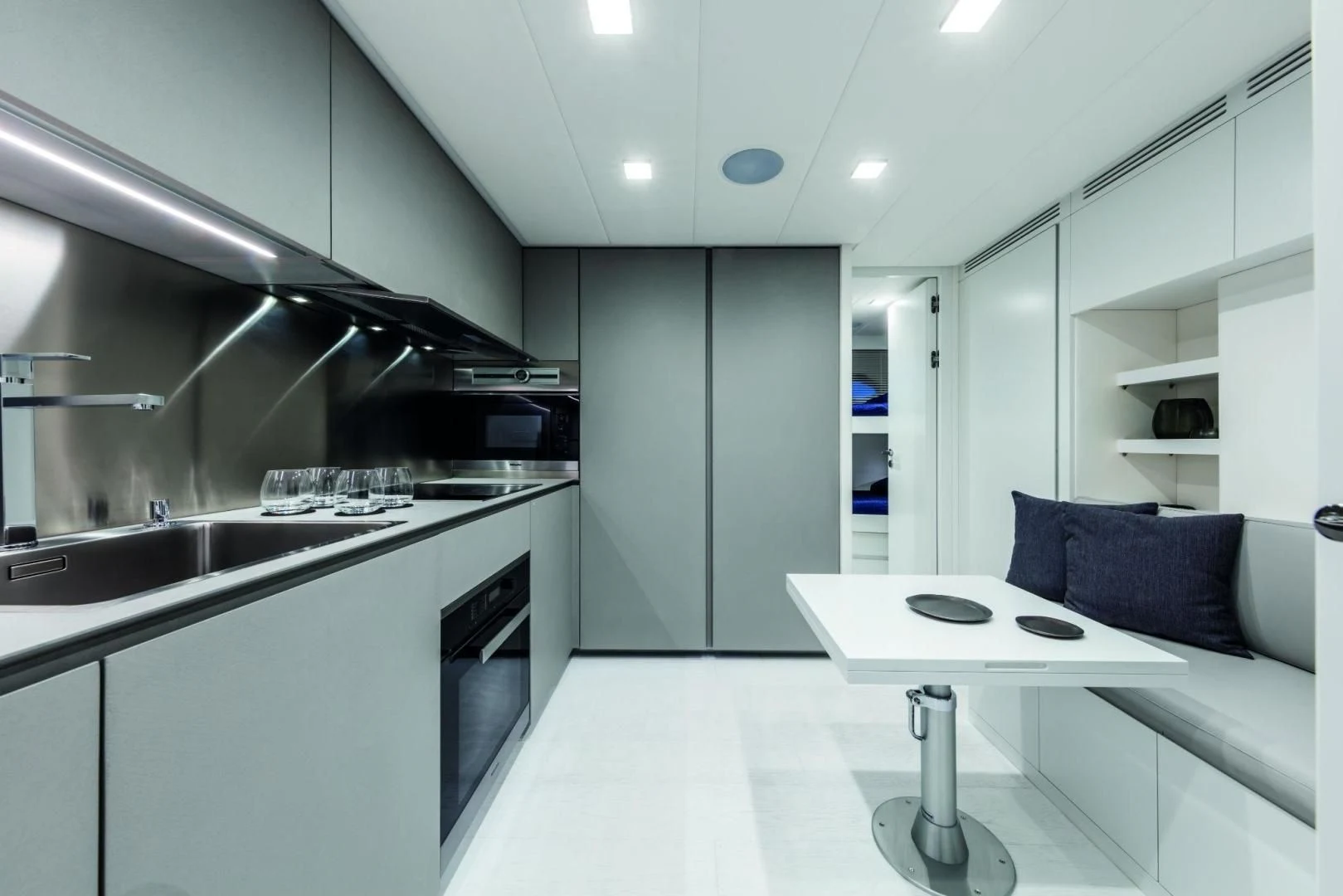 a kitchen with a white table aboard STALLION Yacht for Sale