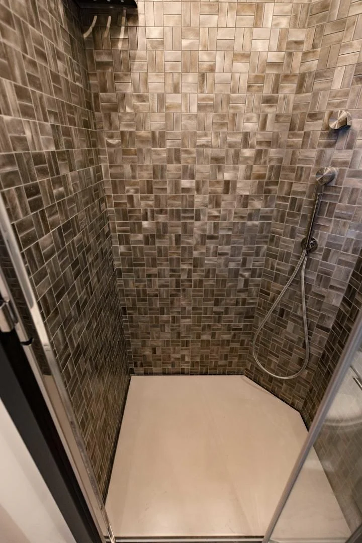 a shower with a tile wall aboard STALLION Yacht for Sale