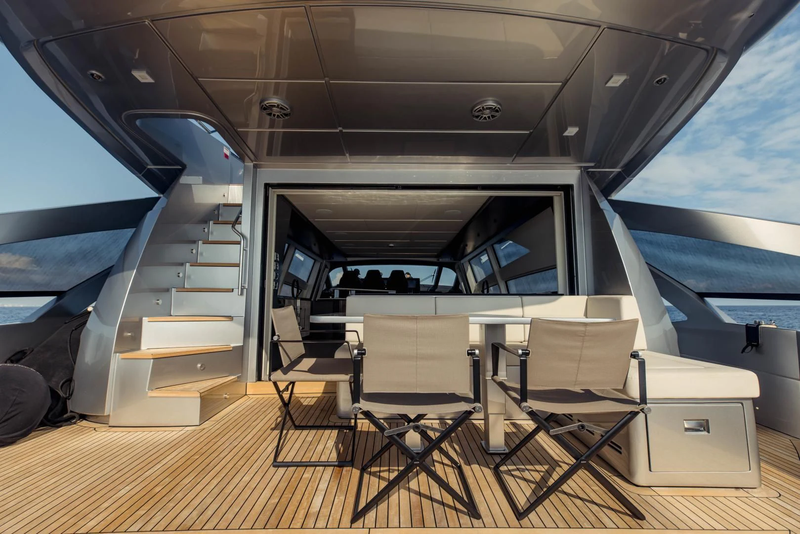 a room with a staircase and chairs aboard STALLION Yacht for Sale