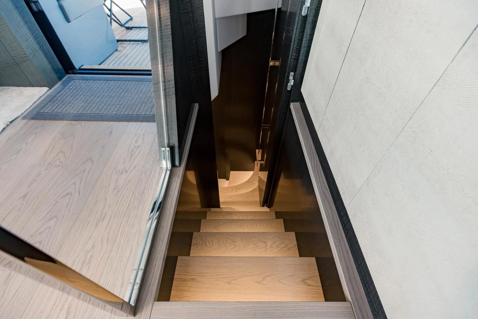 a wooden staircase with a glass door aboard STALLION Yacht for Sale