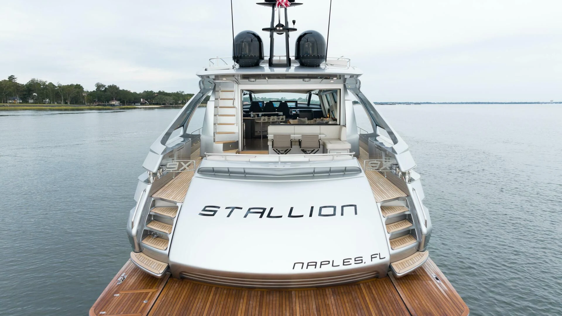 a white boat on a dock aboard STALLION Yacht for Sale