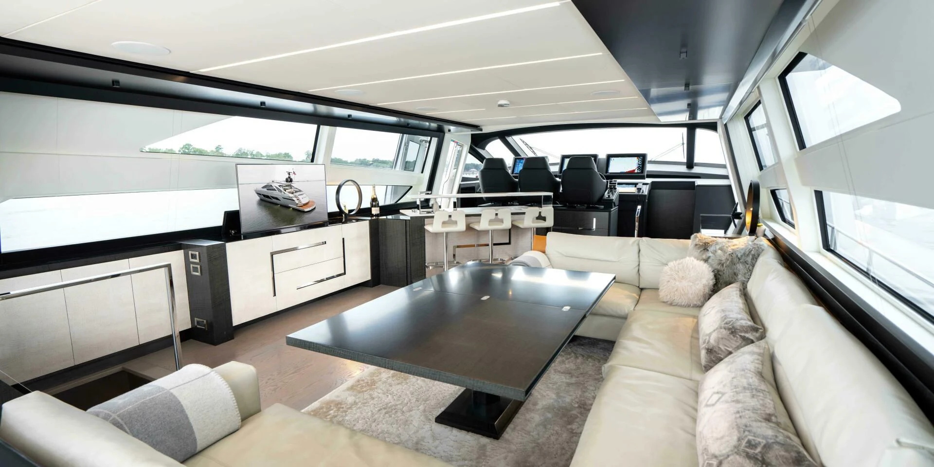 a living room with a couch and a table aboard STALLION Yacht for Sale