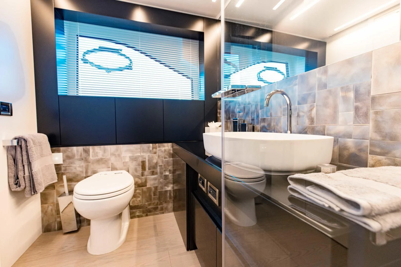 a bathroom with a sink toilet and a mirror aboard STALLION Yacht for Sale