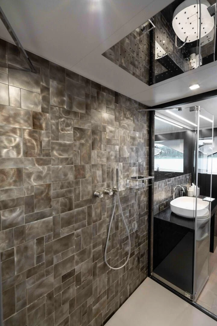 a bathroom with a stone wall aboard STALLION Yacht for Sale