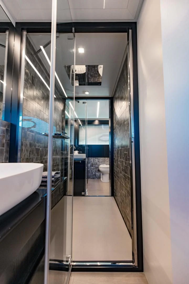 a bathroom with a glass shower aboard STALLION Yacht for Sale