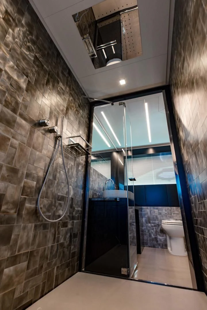 a bathroom with a glass shower aboard STALLION Yacht for Sale